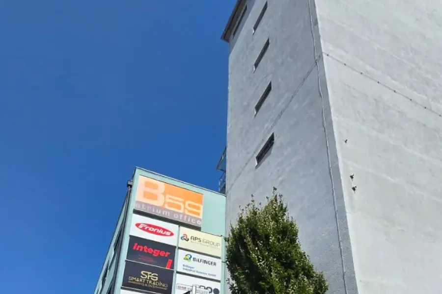 Blick von unten auf das Gebäude mit den Firmentafeln